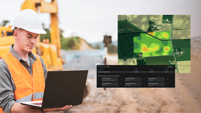A construction worker in a white hard hat looking at a laptop with an inset digital image of a green field,A construction worker in a white hard hat looking at a laptop with an inset digital image of a green field