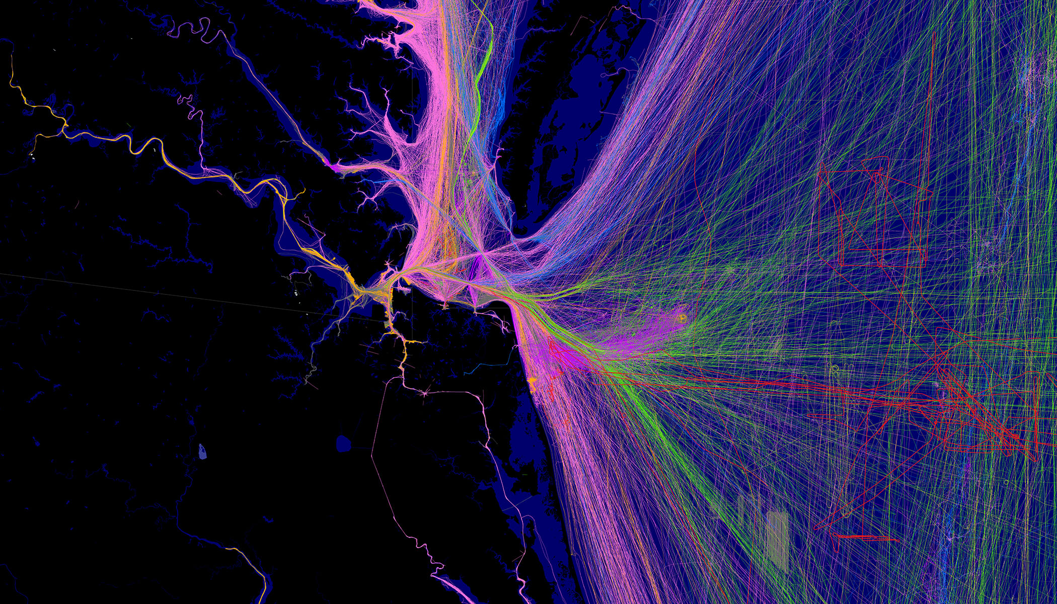 Real-time data visualization of transportation or movement patterns, with neon lines in purple, pink, and green spreading across a dark map, showing high-traffic pathways.