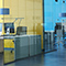 Art of office workers and home office workers in various buildings showing a hybrid work environment.
