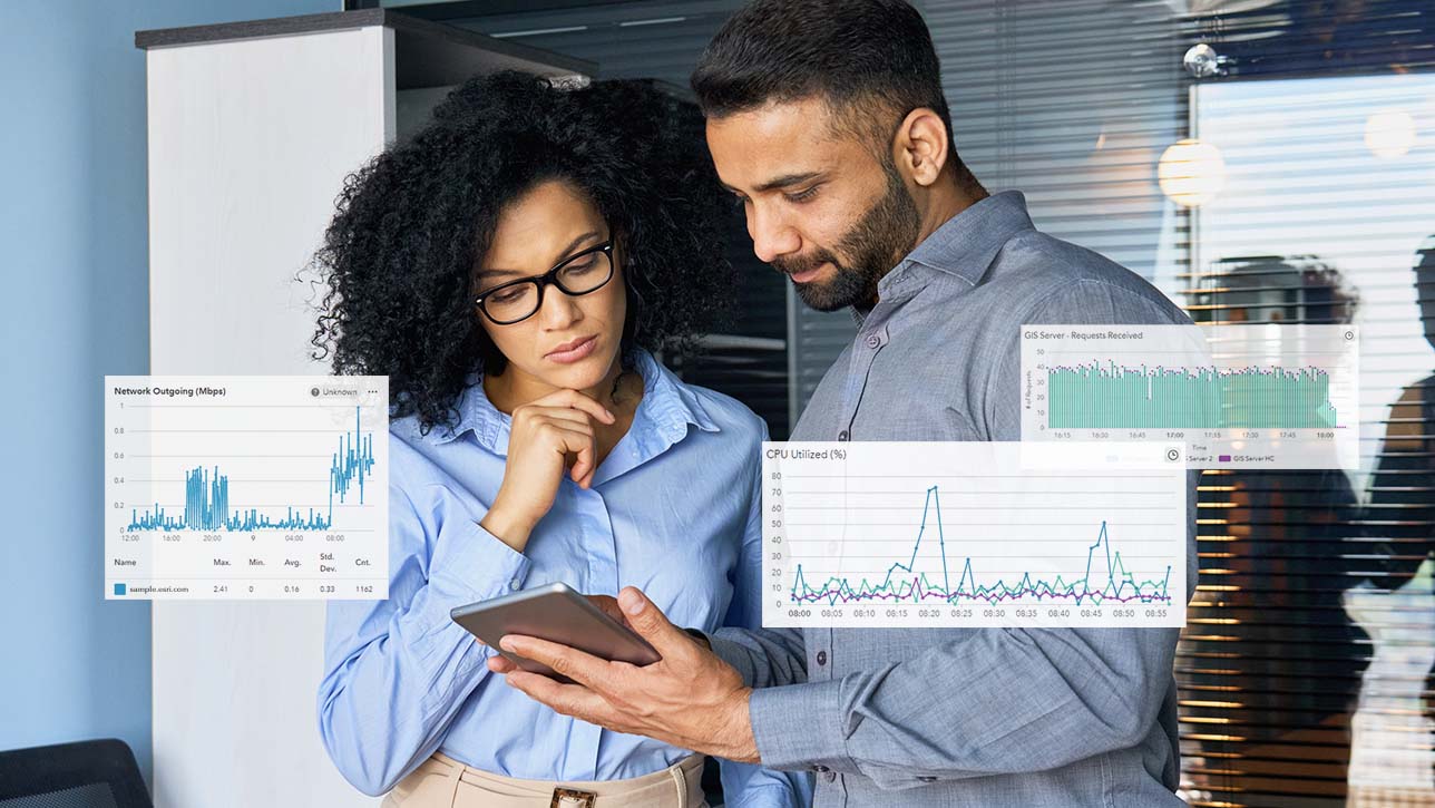 A man and a woman in a server room looking at a tablet with line graph drawings overlayed on the image 