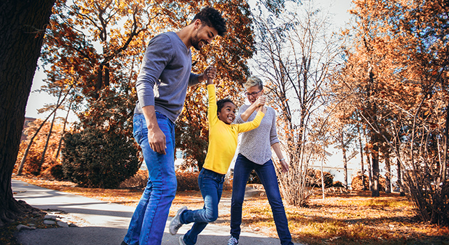 Two adults holding a child’s hand