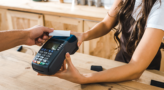 Person paying a bill with a mobile credit card reader
