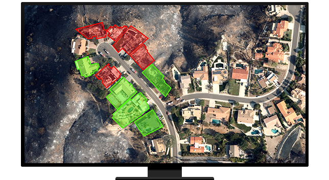 A graphic of a computer monitor displaying an aerial photo of a suburban neighborhood with several houses highlighted in red and green