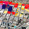 An aerial photo of an urban city with several buildings highlighted in purple, red, or yellow