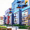 An external photo of a colorful modern apartment complex under a pale hazy sky