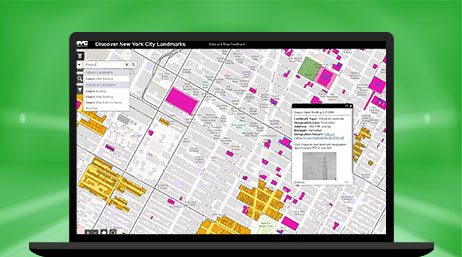 A laptop computer showing a gray map with pink, yellow and green highlighted sections