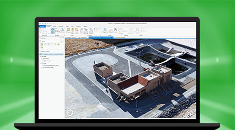 A laptop computer tablet showing ArcGIS Drone2Map open with a drone image of a worksite building
