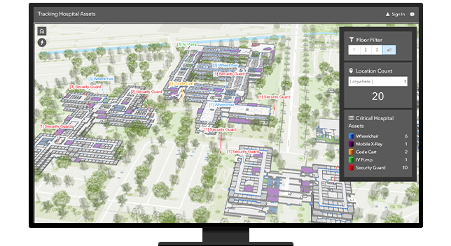 A desktop computer showing a map of a hospital with separated floors and red lines pointing to where the assets are in each building 