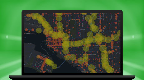 A laptop displaying a map with small red circles and larger yellow circles