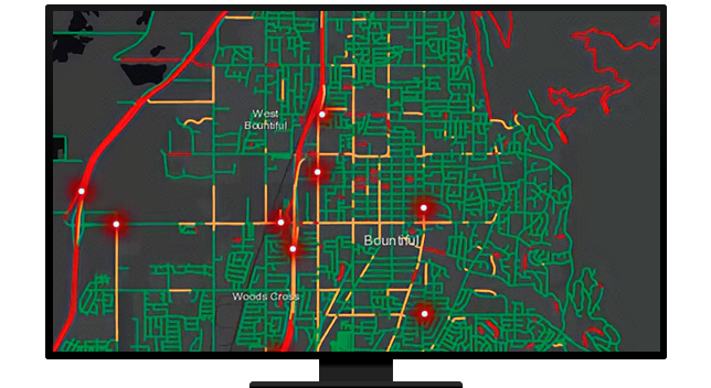 A computer displaying a map of green, yellow, and red lines with glowing red points 