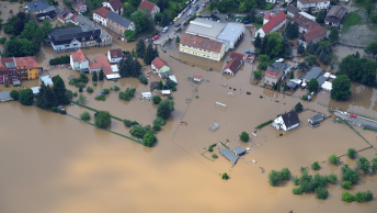 An aerial view of a town flooded with brown water