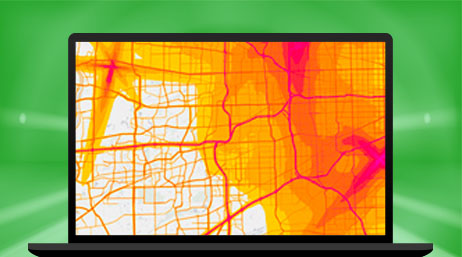 A laptop displaying an orange and pink shaded map with red lines