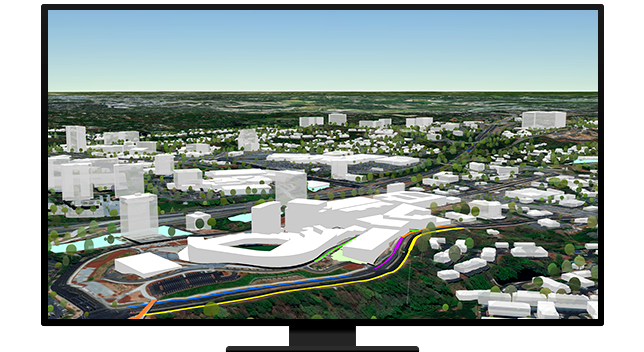 A computer displaying a 3D city with white buildings, green landscaping, and colored roads 