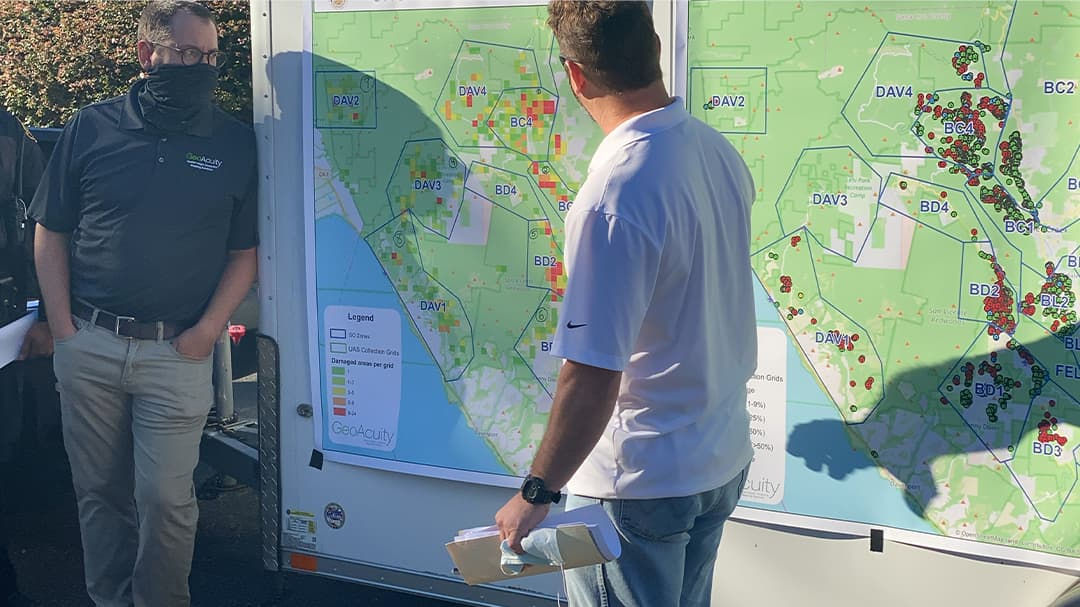 team members looking at paper map of fire boundaries